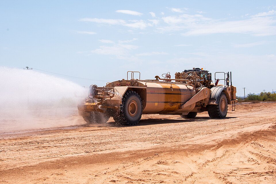 Water truck spraying water for dust suppression on a construction site